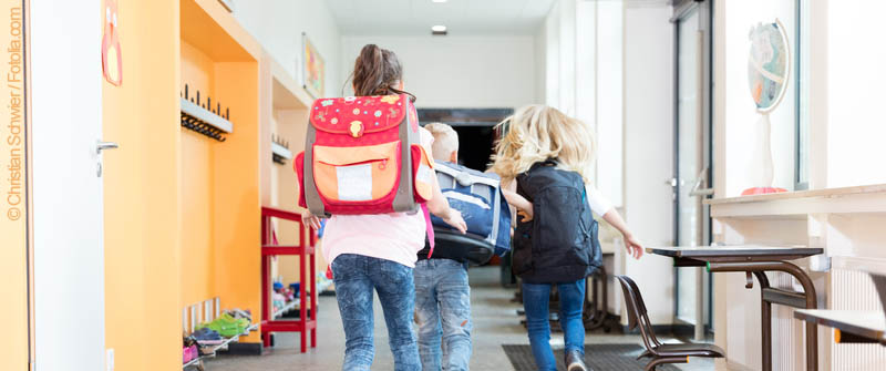Schulbezogene Sozialarbeit an der Hermann-Boddin-Schule, Berlin Neukölln, rennende Kinder mit Schulranzen